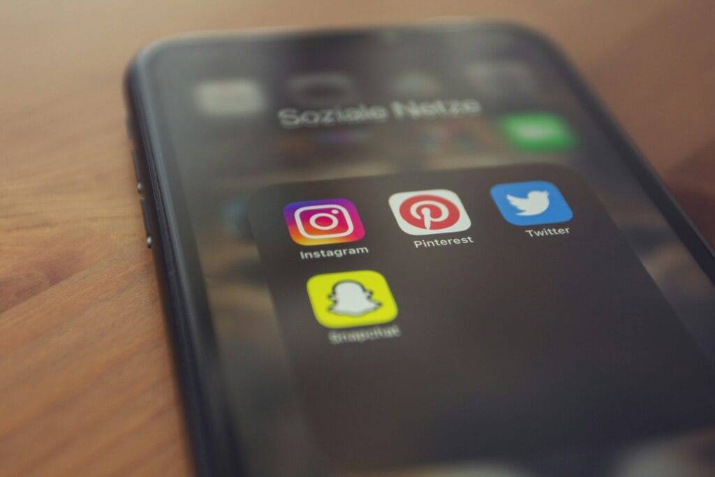 phone with social media widgets on the screen - Arise Hotel Marketing